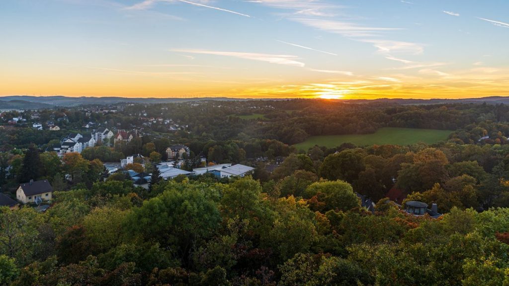 A photograph of an autumn sunset from Barenstein hill above Plauen city in Germany